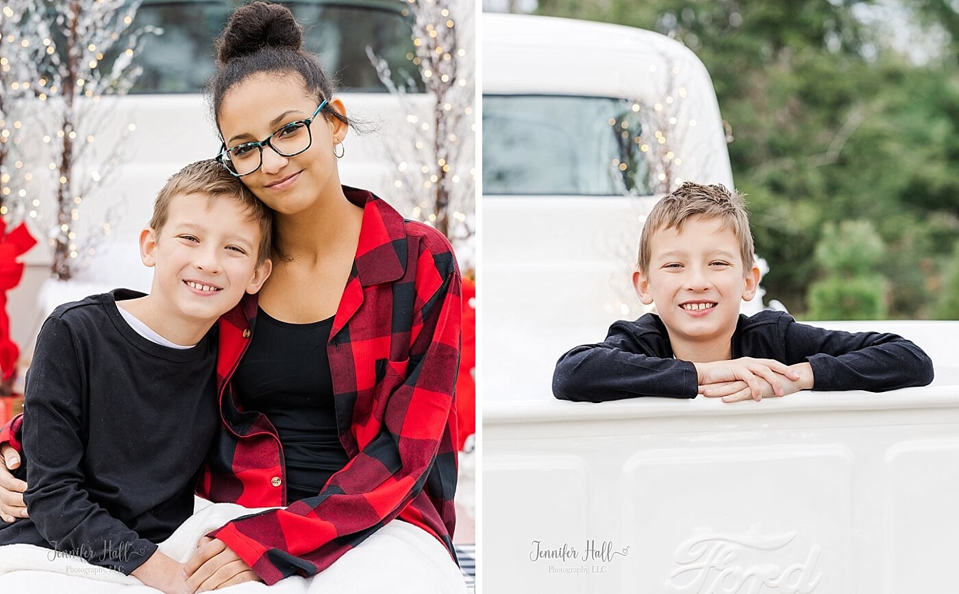 Sister with her arm around her brother and her brother by himself in the back of a white truck.