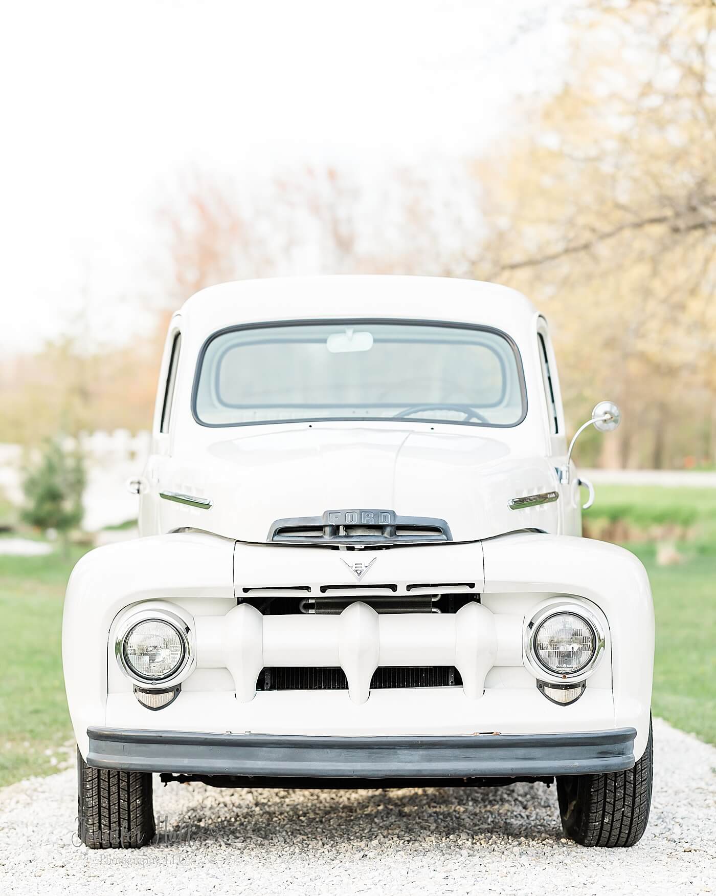 Jennifer Hall Photography, LLC’s white 1951 Ford truck for family photography sitting outside during spring in North East, PA.