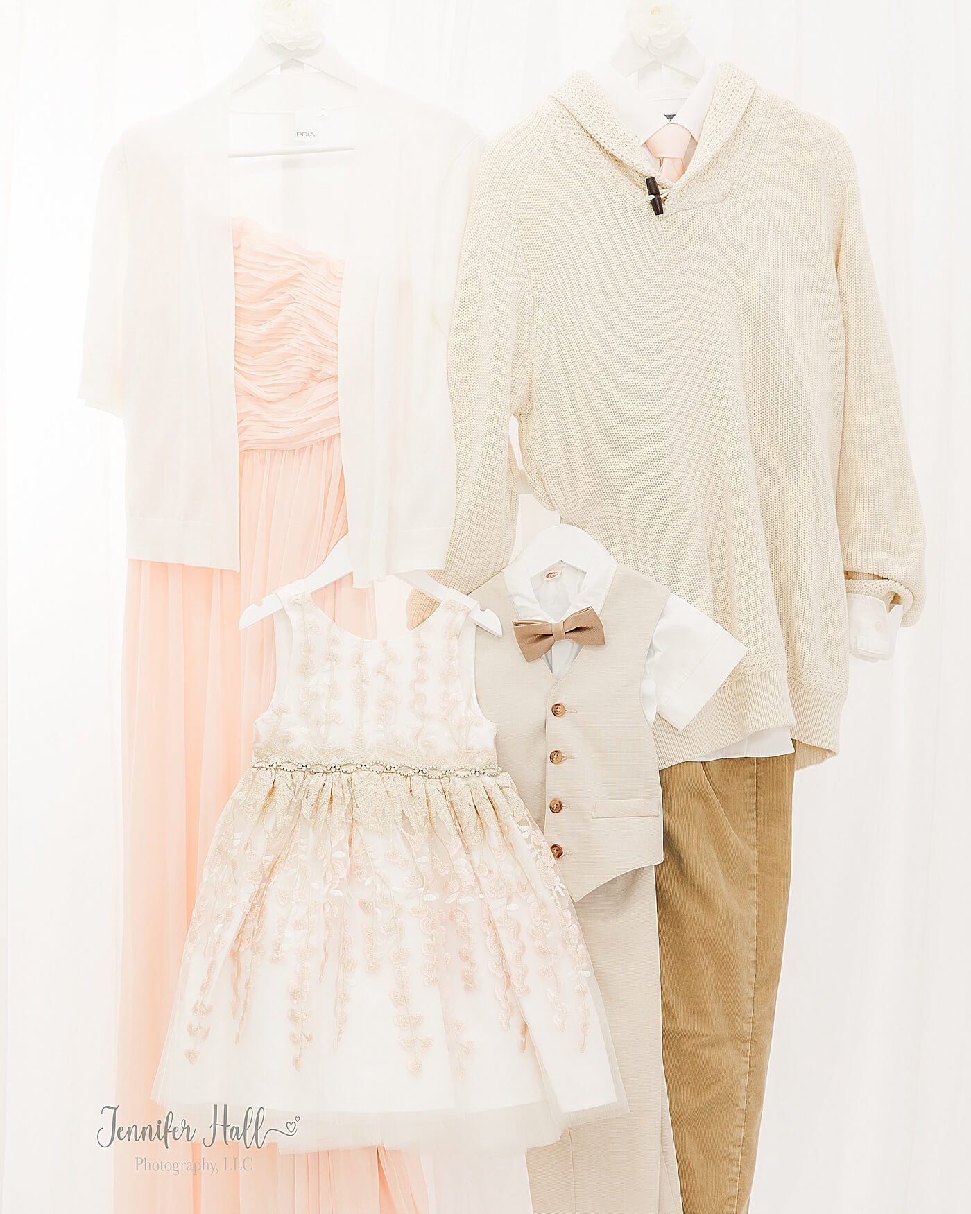 Woman’s vanilla blush dress with a white sweater; a man’s beige sweater with a white collared shirt; a girl’s white dress with beige and vanilla blush designs; and a boy’s white collared shirt with a beige suit vest to show styling tips for him for family photos.