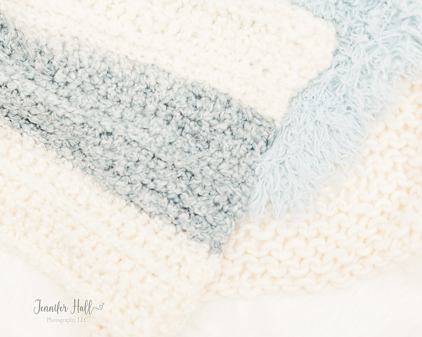 Cream, white, and powder blue blankets for a little boy and his family to sit on for portraits.