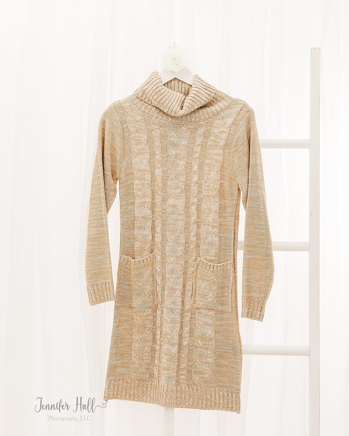 French gold sweater dress hanging up in a studio to show family portrait session outfit tips for styling girls.