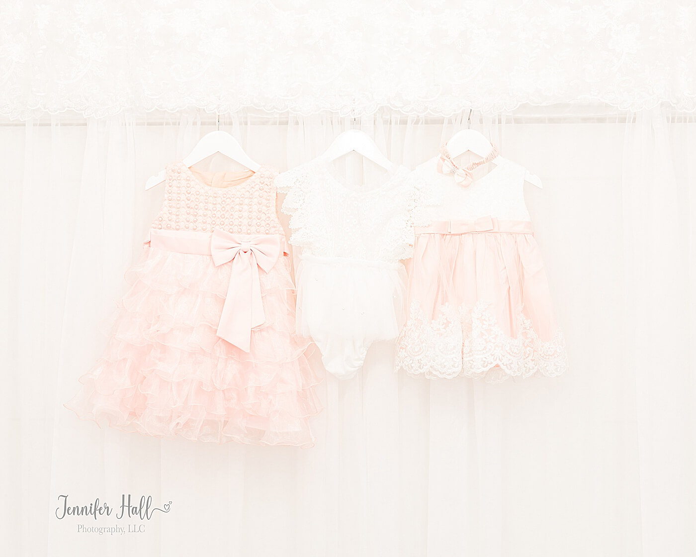 Little girls' clothes of a vanilla blush dress, white romper, and white and vanilla blush dress to show little girl portrait session outfit ideas.