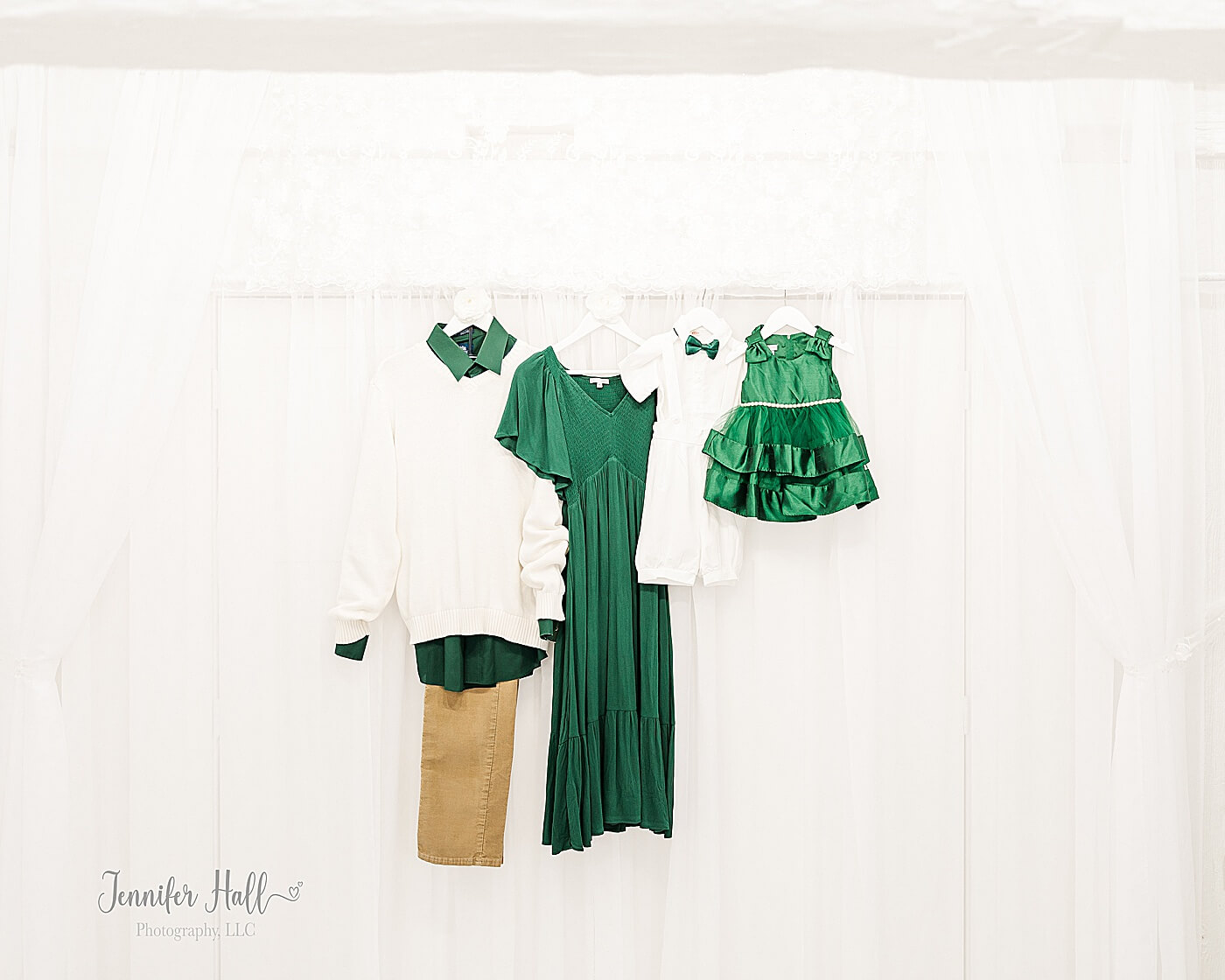 An evergreen dress, cream sweater with an emerald collared shirt, an emerald dress, and a white collared shirt with an emerald bow tie for what to wear for Christmas family photo outfits.