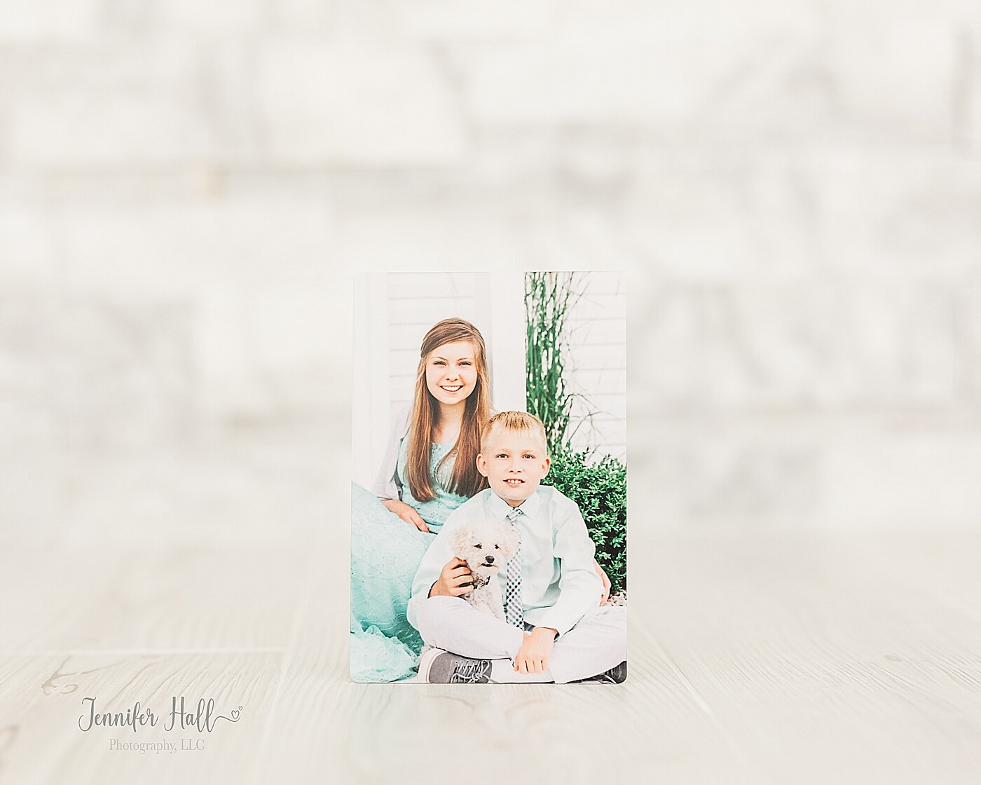 Metal print with a photo of a girl and a boy outdoors for a family photo gift idea for Christmas.