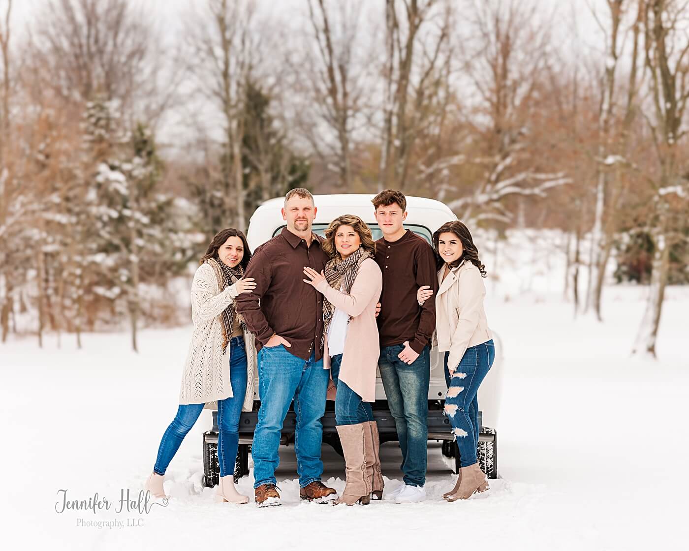 Family wearing blush, cream, and brown outfits for preparing for your family photo session.