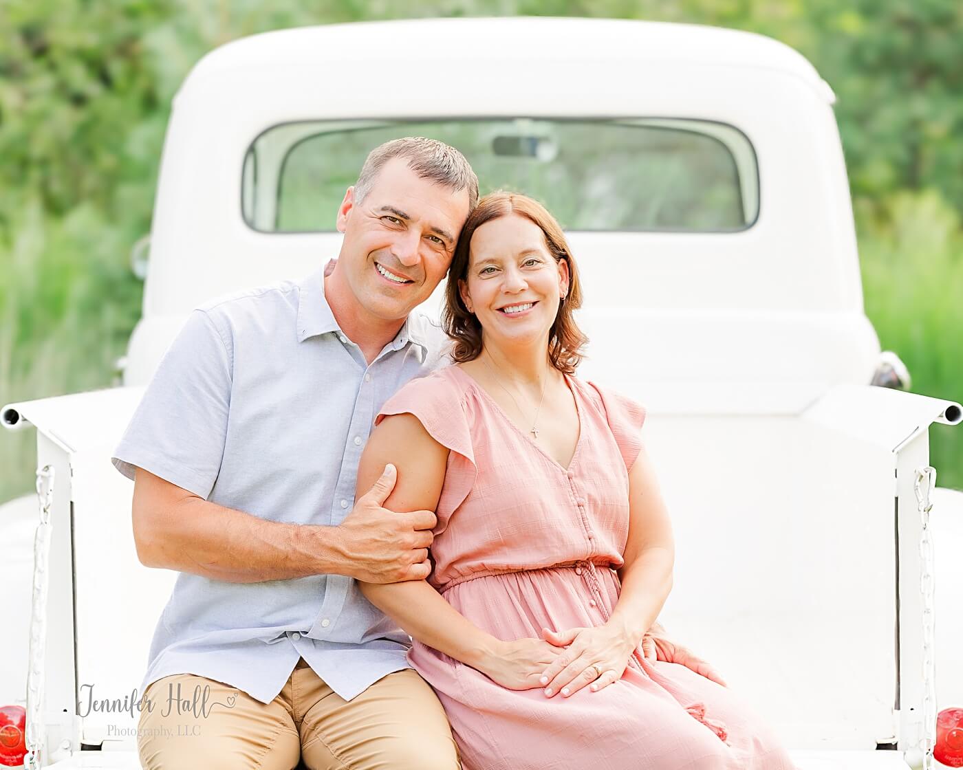 Man with tan pants by his wife to show a men’s photo clothing idea.