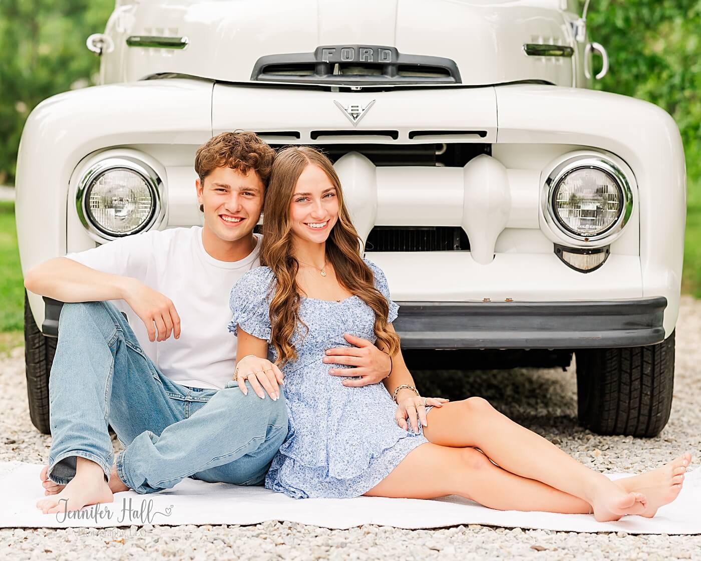 Couple sitting by a white truck for timeless couple’s pictures in North East, PA.