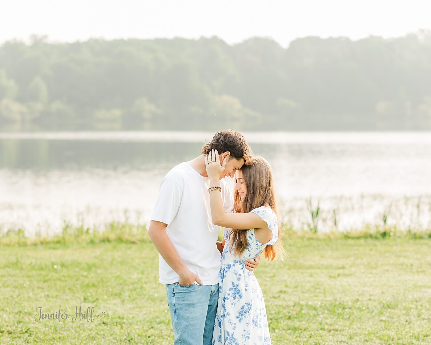 Couple standing close in a grassy field near Howard Eaton Reservoir in North East, PA.