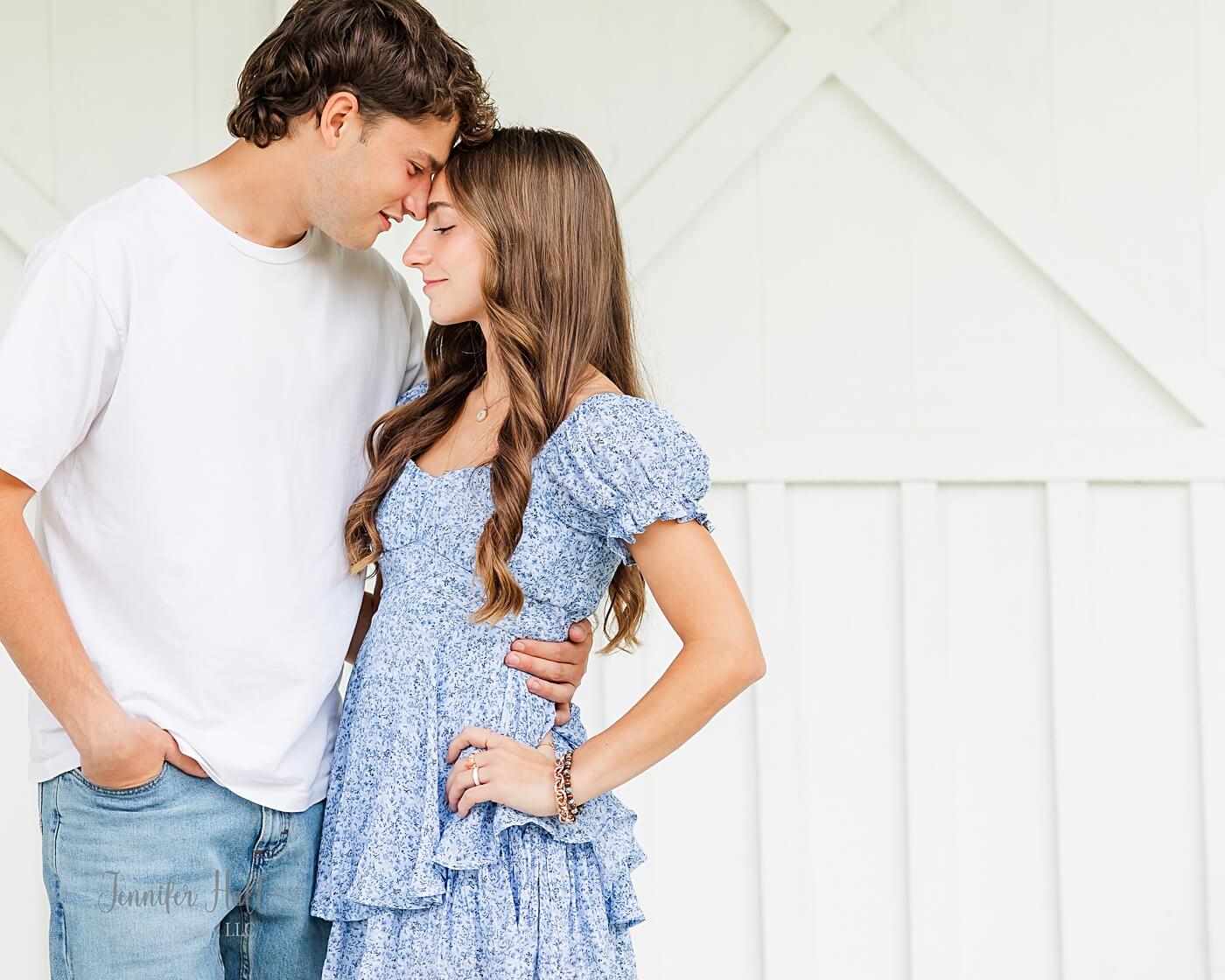Couple standing at the outside grand entrance for a North East, PA, couple’s picture session.