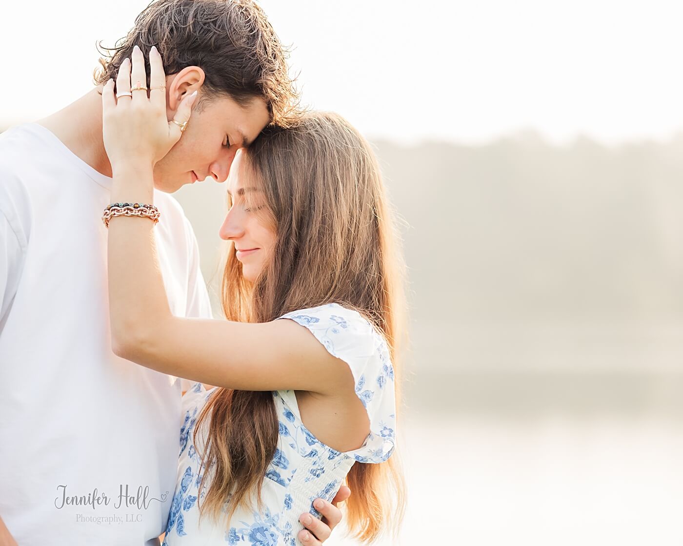 Couple standing together and holding each other close at Howard Eaton Reservoir for couple’s photos.