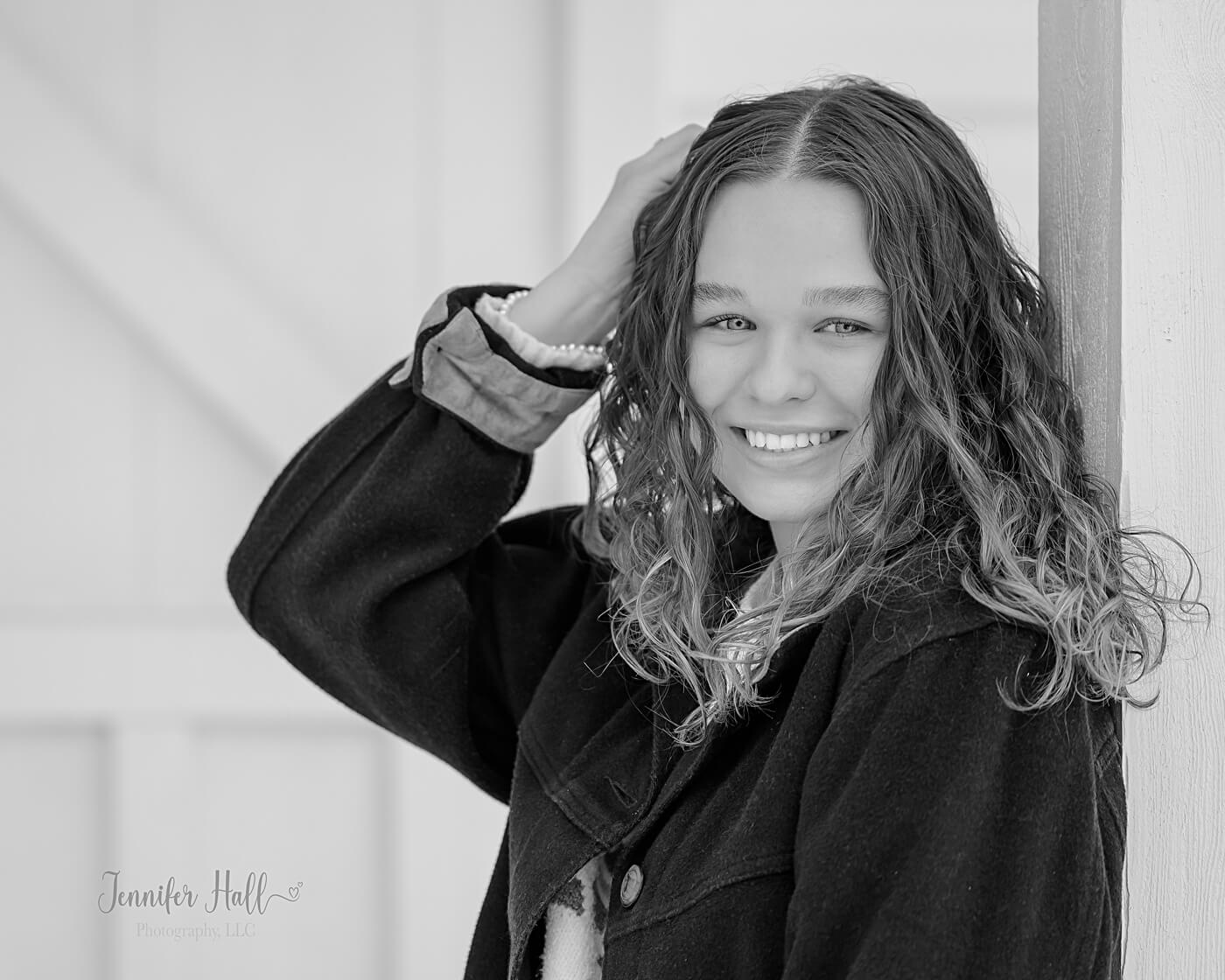 Girl standing outdoors at the grand entrance during winter.